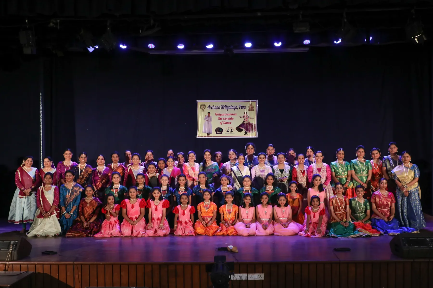 The full company of Archana Nrityalaya Pune, students of every age, assembled on stage after the annual gathering