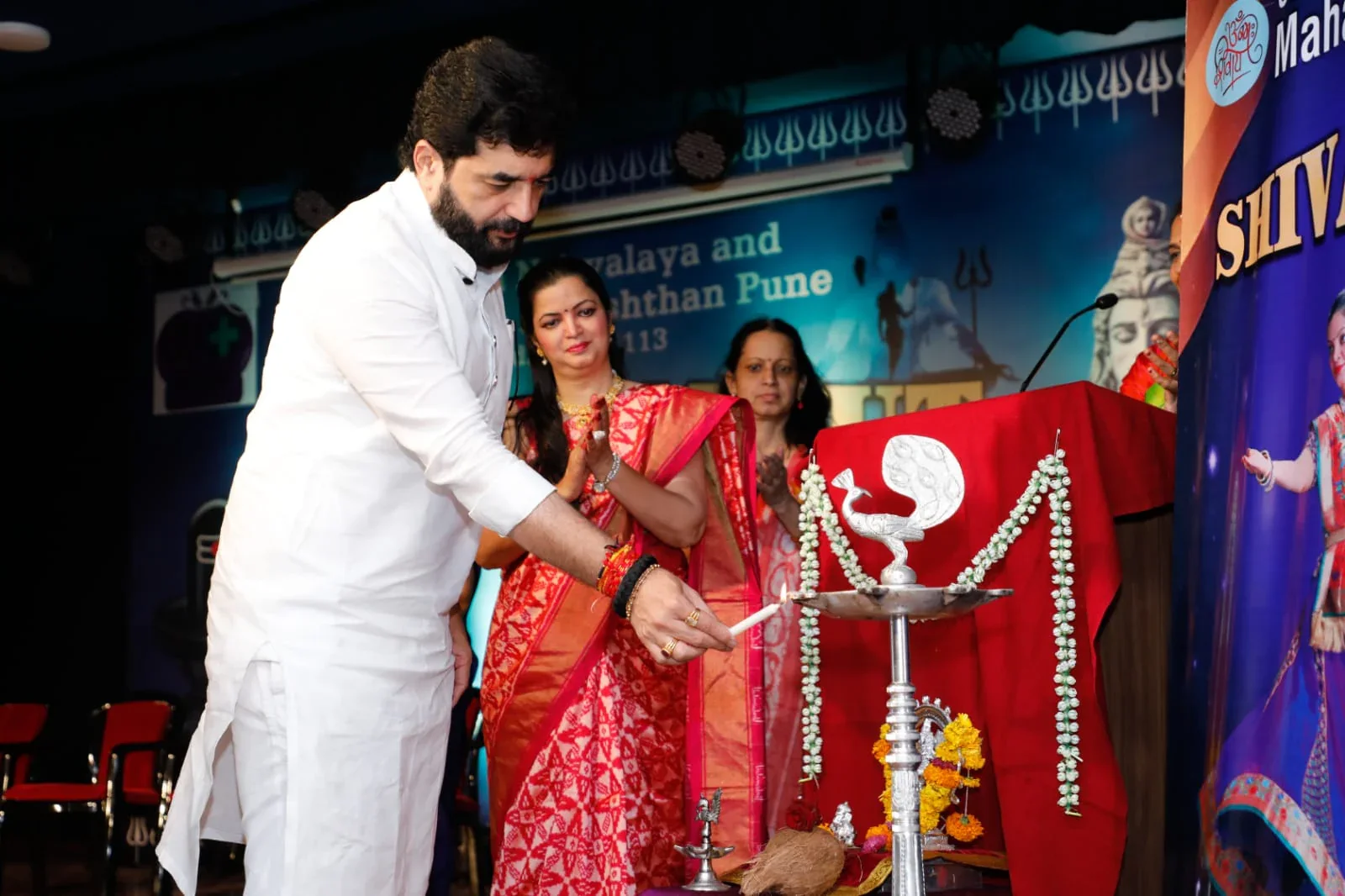 Murlidhar Mohol lighting the ceremonial lamp while Guru Archana Patwardhan looks on at ANVPP's 2024 event